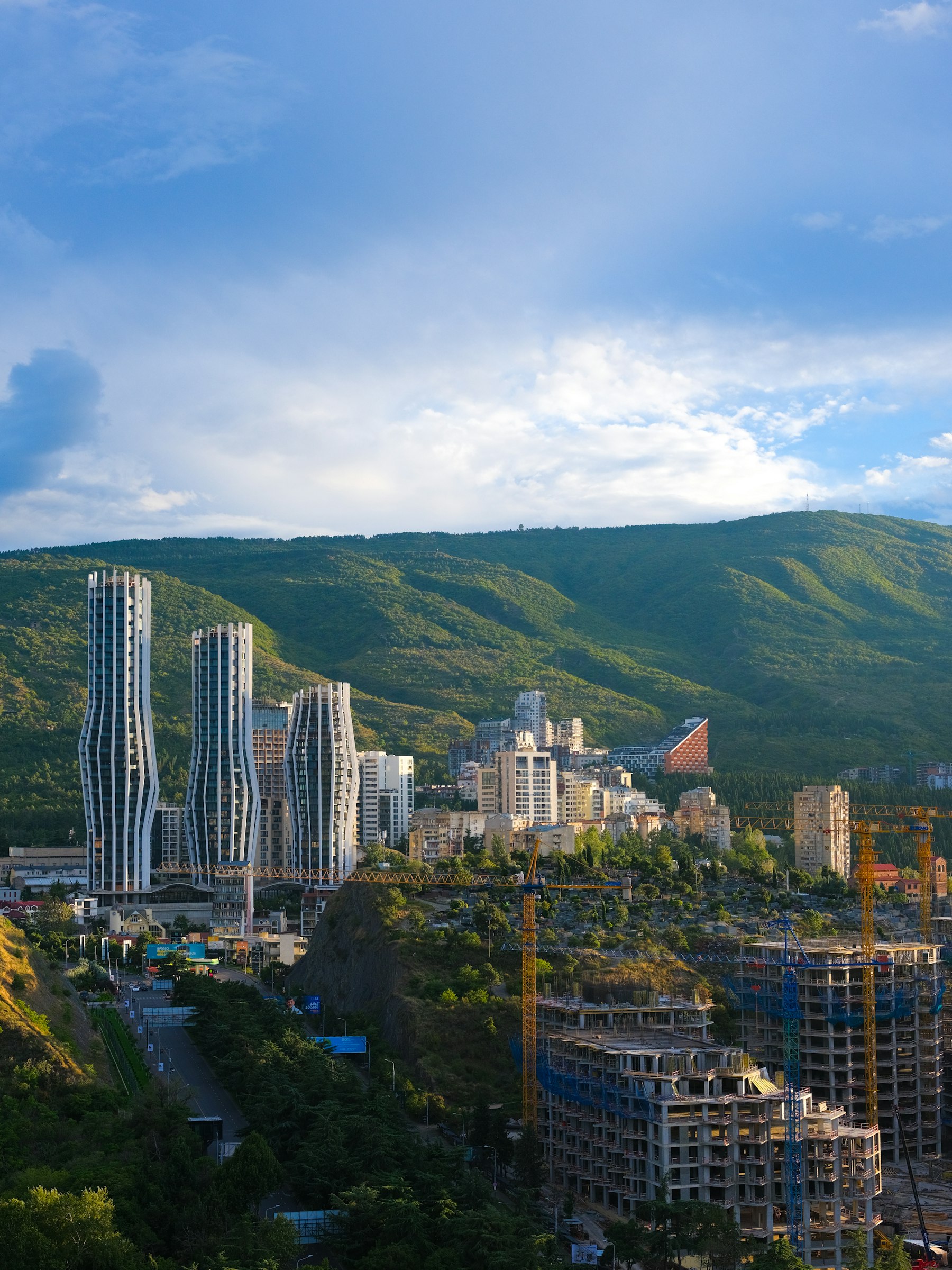 Tbilisi skyline against green hills
